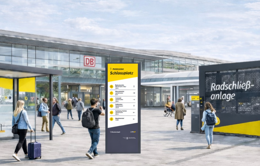 Grafik Mobilstationen/mit KI generiert Grafische Darstellung einer Mobilstation vor einem Bahnhof mit Infosäule, Haltestelle und Radschließanlage